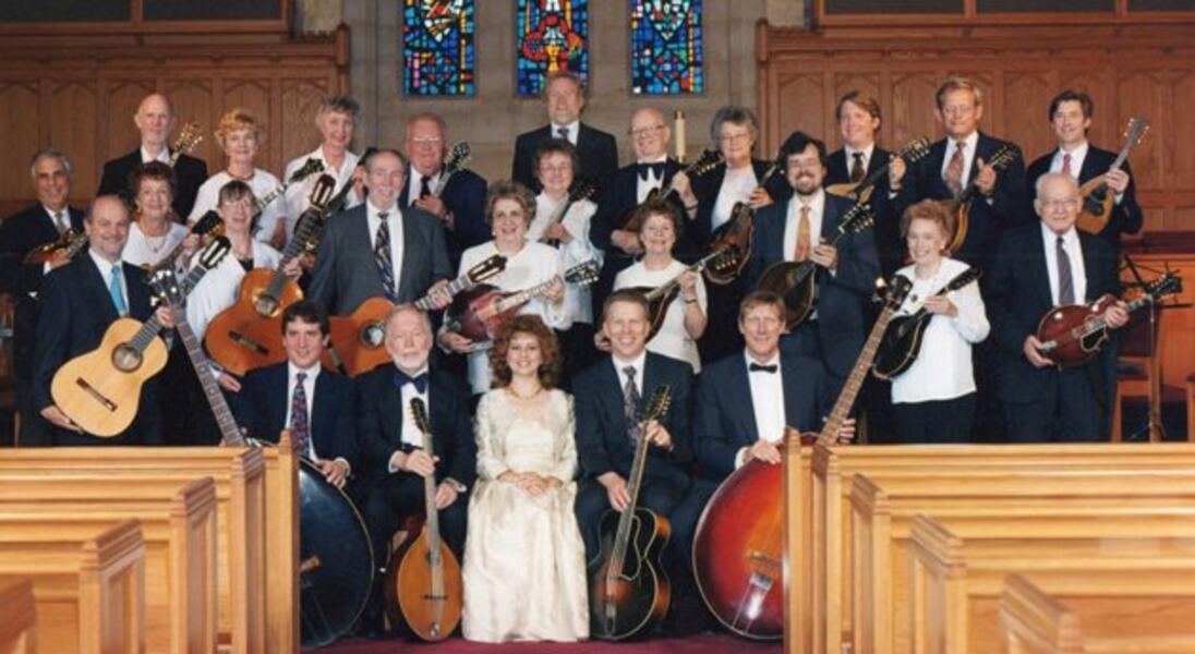 The Baltimore Mandolin Orchestra, 1999, with director David T. Evans (standing, center rear) and soprano Beatrice Gilbert (seated, front row, center)