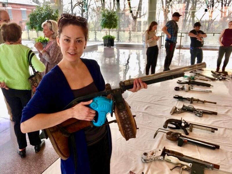 Woman holding gun sculpture